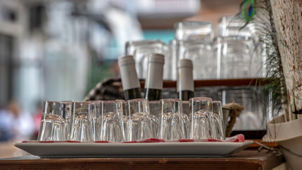 Inverted liqueur wine glasses on the blurred background. Greece