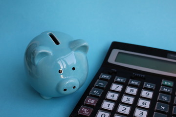 piggy piggy bank standing near a calculator