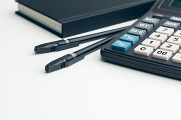 Business still life with calculator on table in office.