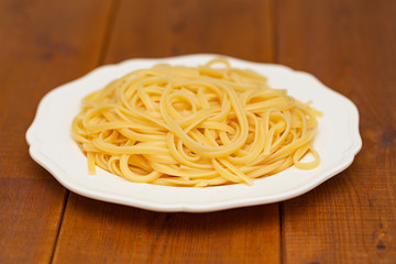 cooked spaghetti on white plate