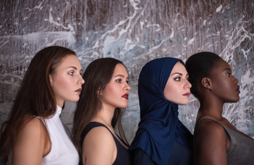 Portrait of four girls with different skin color and nationality in the studio