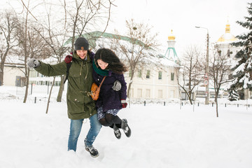 Fototapeta na wymiar Happy Young Couple in Winter Park having fun.