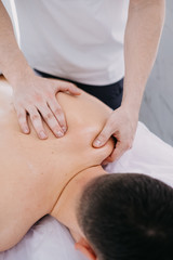 Fototapeta na wymiar Sports massage. Therapist working with shoulders