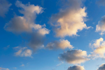 Naklejka na ściany i meble beautiful blue sky with sunlit clouds as a natural background
