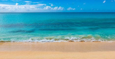 Caribbean white sandy beach and crystal clear ocean. Tropical summer holiday beach.