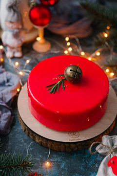 Red Christmas cake, on a blue background with garland and red balls