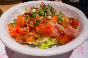 Close up Fresh salmon raw spicy salad.