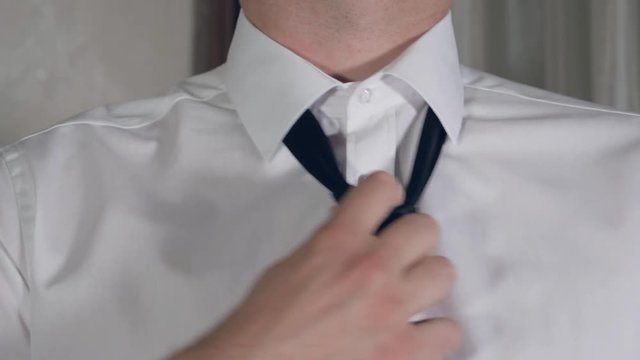 Men Hands Take Off The Tie And Unbutton The Shirt At Home After Work