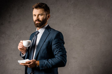 handsome businessman standing with cup of coffee