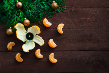 New Year and Christmas concept. fir branches, candles and mandarin. winter mood. selective focus
