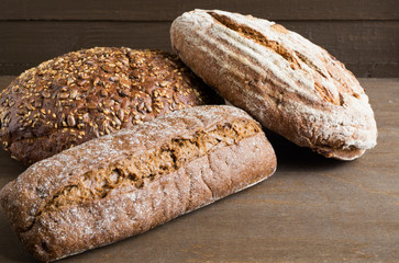 Homemade rustic rye bread on a dark background.