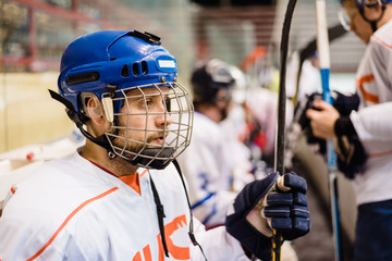 hockey players sit on the bench during the match