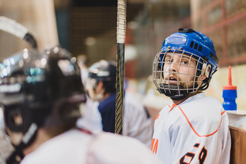 hockey players sit on the bench during the match
