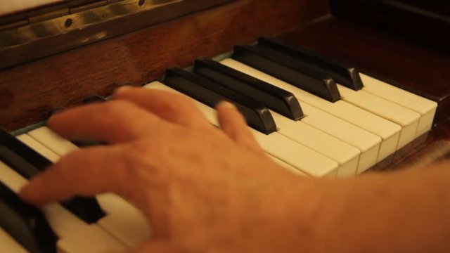the hand of the pianist glide over the keys