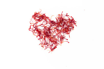 heart made with saffron red gold of sardinia isolated on white clean background