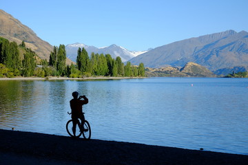 Cyclist silhouette and lake, Wanaka, New Zealand