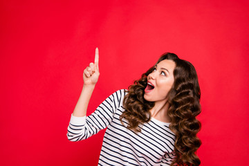 Close up portrait of beautiful cute attractive she her girl with finger in top of empty space shocked with new prices wearing white sweater outfit isolated on red vivid bright background