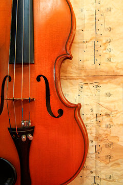 Old violin on the background of notes
