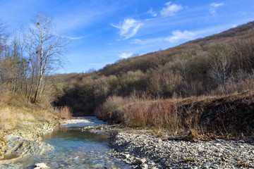 mountain river, winter forest and blue sky