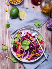 Healthy winter salad with red cabbage, baked chickpeas, carrot, beetroot, spinach, vitamin food