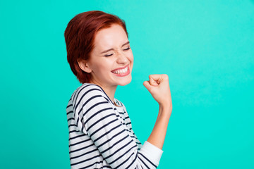 Profile side view portrait of nice adorable attractive pretty excited red-haired lady in striped...