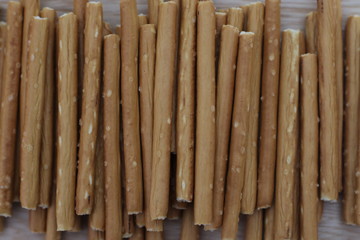 Salty stick crackers on wooden desk