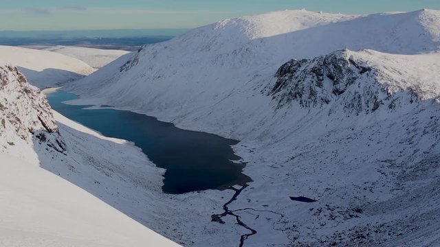 overlooking loch avon in the cairngorms national park during the first snow of winter.
