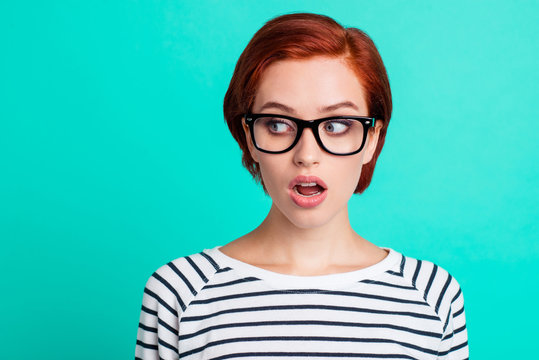 Headshot photo portrait of staring aside to the left copy space amazed shocked with shirt hairstyle raised eyebrows she her person in modern apparel isolated teal vivid background
