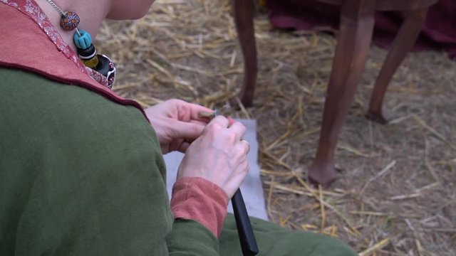 A Medieval Woman Cuts A Doll In Wax