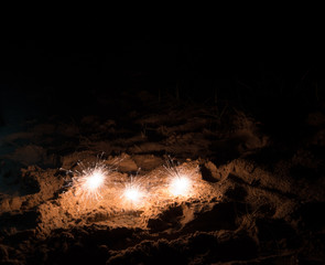 Sparklers in the sand on a beach