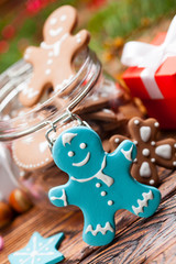 Colorful Christmas cookies in a jar and wooden table