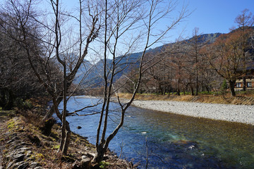 Beautiful crystal clear water river landscape with mountain background in Japan Alps Kamikochi