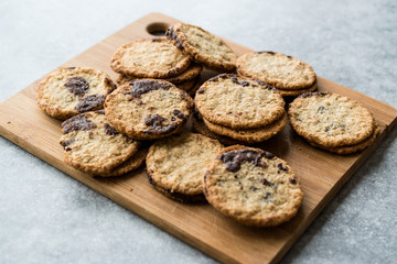 Classic Swedish Oatmeal Cookies with Chocolate on Wooden Board.