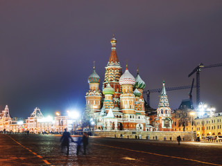 Fototapeta premium Famous landmarks - St. Basil Cathedral on Red square in Kremlin. Winter evening in Moscow, Russia.