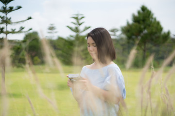 Naklejka na ściany i meble Happy young cute asian girl hipster backpack women sitting at beautiful garden outdoor sky mountains scenery views 