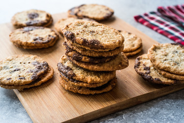 Classic Swedish Oatmeal Cookies with Chocolate on Wooden Board.