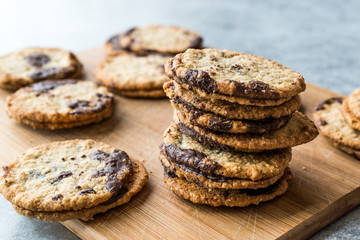 Classic Swedish Oatmeal Cookies with Chocolate on Wooden Board.