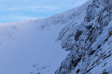 half way up the cliff face at the end of sneachda in the cairngorms national park, scotland looking towards carn gorm with snow and ice in winter