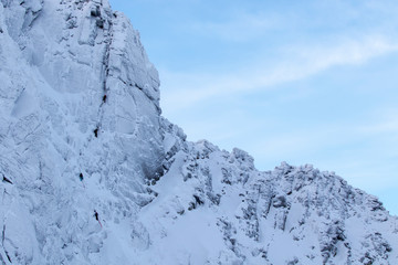 fiacaill ridge of sneachda within the cairngorms national park, scotland covered in the first snows of winter with climbers