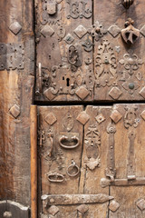 Heavily decorated old wooden door in Estella or Lizzara, Navarre Spain, detail