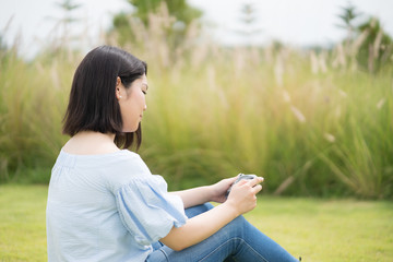 Happy young cute asian girl hipster backpack  women sitting at beautiful garden outdoor sky mountains scenery views 