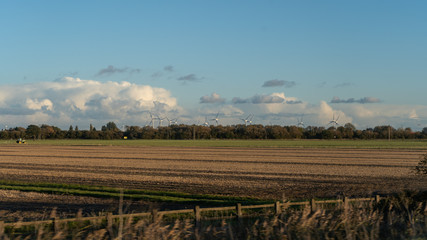 A view of a cultivated field in England during a golden hour.