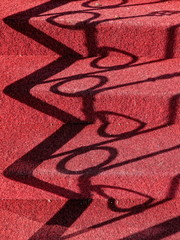 Stairs and shadows on red carpet