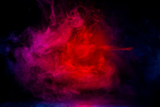 red and blue smoke patterns at dark background