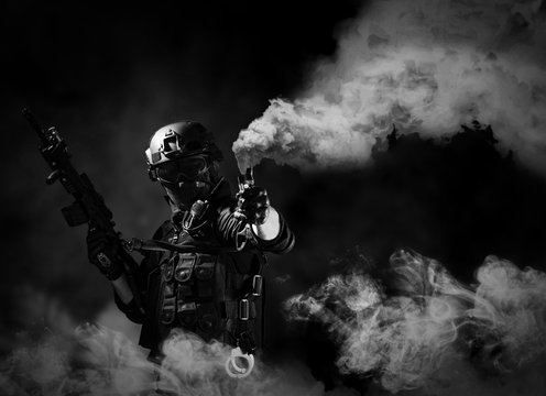special forces soldier police, swat team member using smoke bomb