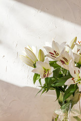 Flower bouquet, white lilies in a vase. White background. 