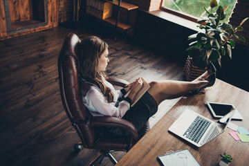 Above high angle profile side view of nice attractive glamorous slim elegant wavy-haired lady professional sales manager long legs on table at workplace station open space