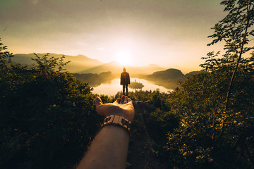 Person enjoys a beautiful sunrise at Lake Bled in Slovenia
