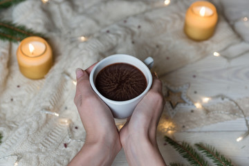 Obraz na płótnie Canvas Female hand holding cup of hot Cocoa or Chocolate