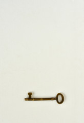Antique brass key on white background with copy space. Concept of old style solving problem technique key.